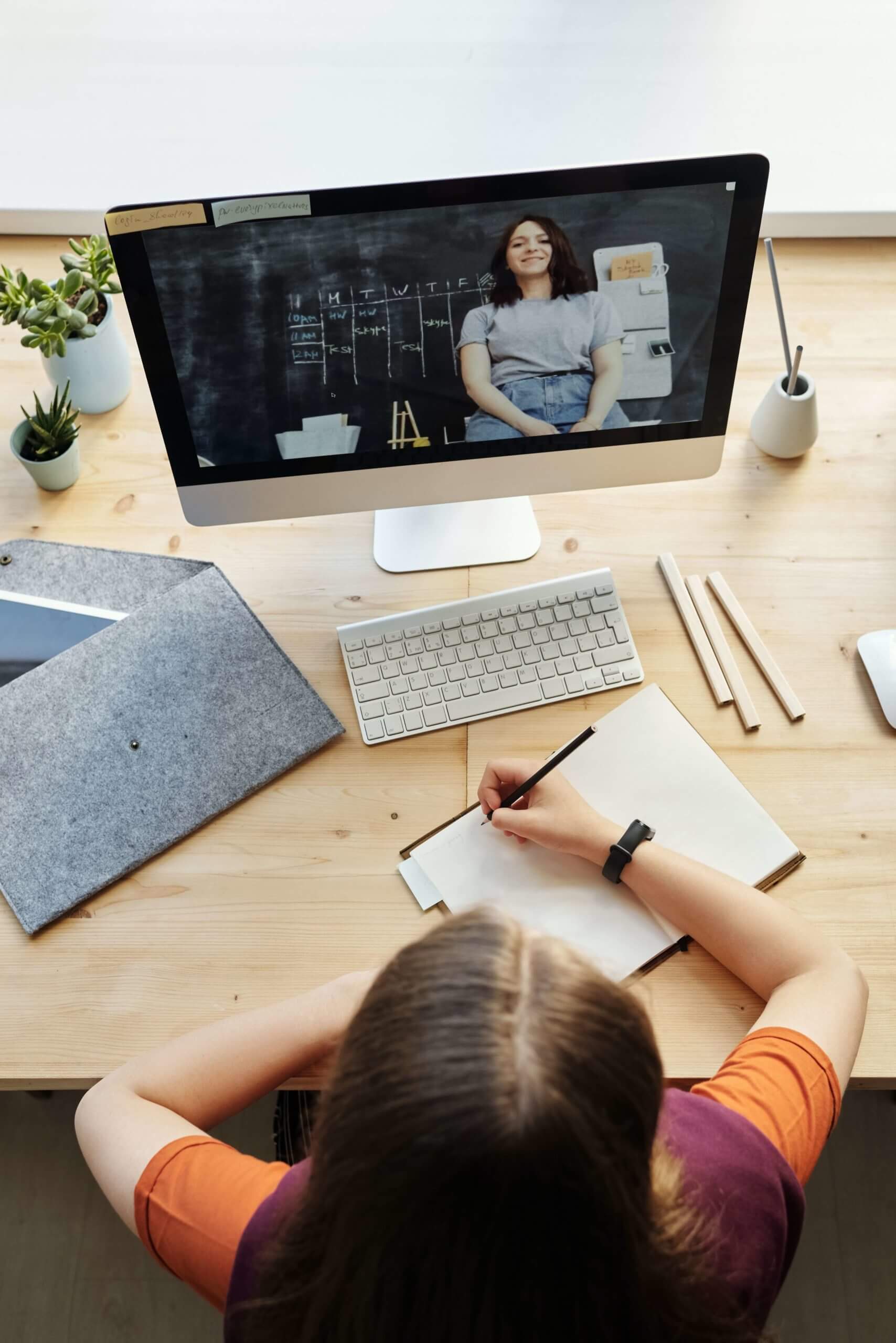 a woman attending virtual learning via computer